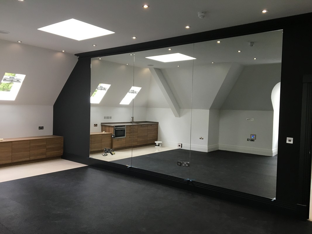 Frameless glass wall dividing loft conversion in Aldgate