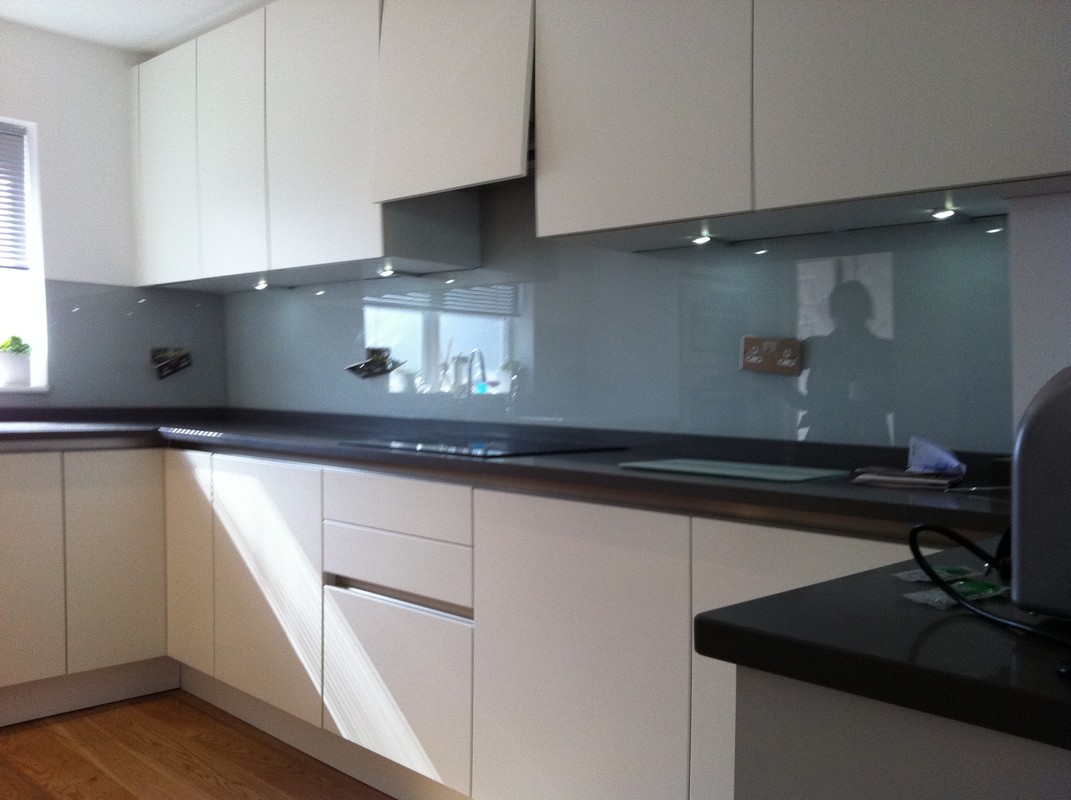 Grey glass kitchen splashback with LED lighting in Aldgate