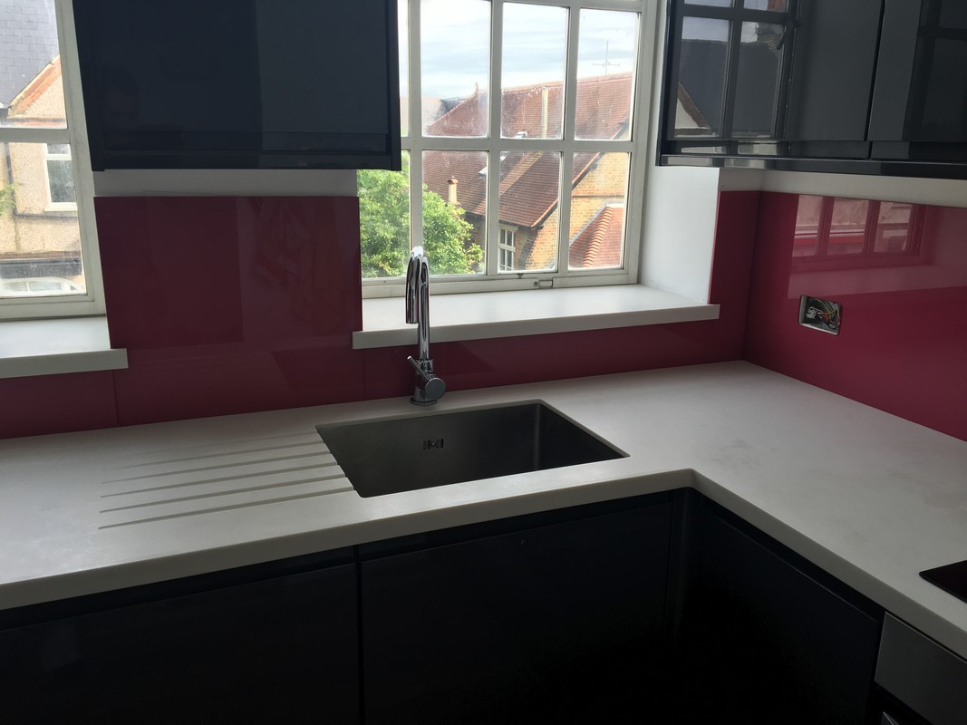 Deep plum coloured glass splashback in modern Aldgate kitchen