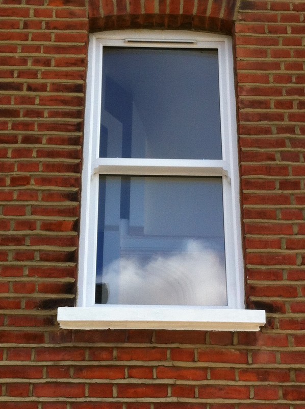 uPVC sash window on Victorian red brick house in Aldgate